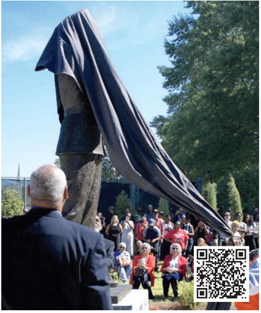 Marshall Little watches as the statue of his father, Hiram Little, is finally revealed before an appreciative crowd in downtown Eatonton.