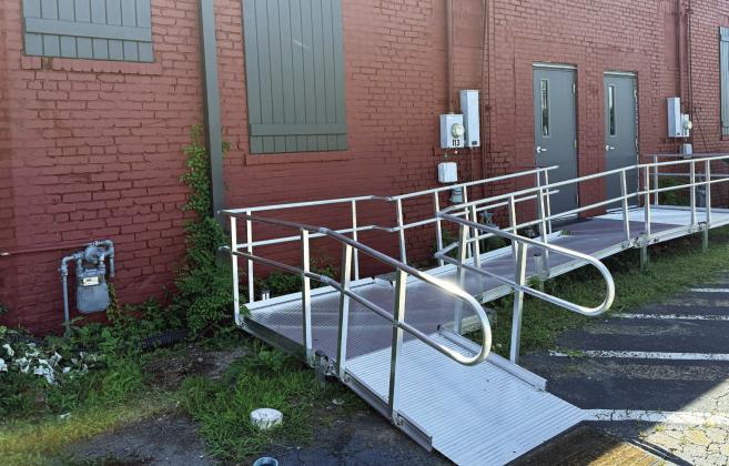 The most prominent features of the refurbished back entrance to the Georgia Writers Museum are the new wheelchair ramp, new doors, and decorative shutters covering long-ago bricked-in window openings. IAN TOCHER/Staff