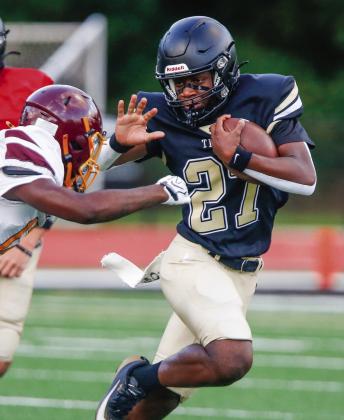 Greene County running back Johnathan Lawrence (27) prepares to stiff-arm a Hancock Central defender during a scrimmage. LANCE McCURLEY/Staff