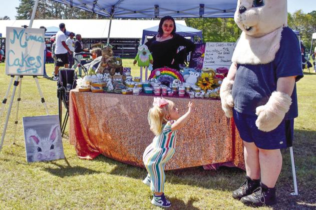 Kennedy Moore dances for the Easter Bunny as vendor Diana Peek of Mim’s Cakes is looking on. The baker of sweet treats at Mim’s Cakes is Peek’s mother, Missy Reynolds, not pictured.