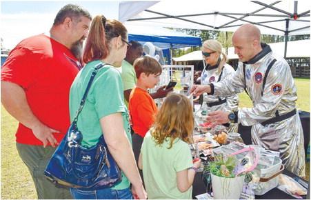 Mary Wright and Zack Allen of Eatonton-based business Astro Candy serve the McDougald family – parents Rich and Nicole and their children Aurelia and Hudson.