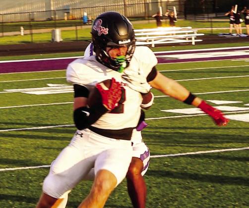 Morgan County wide receiver Cole Wesley fights for extra yardage during a scrimmage against Cherokee Bluff on Aug. 13. JATAVIOUS WARD/Contributed