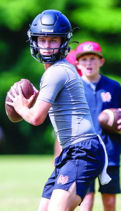 Junior quarterback Gunner Braswell prepares to throw a pass downfield during a 7-on-7 competition at UGA in June. LANCE McCURLEY/Staff