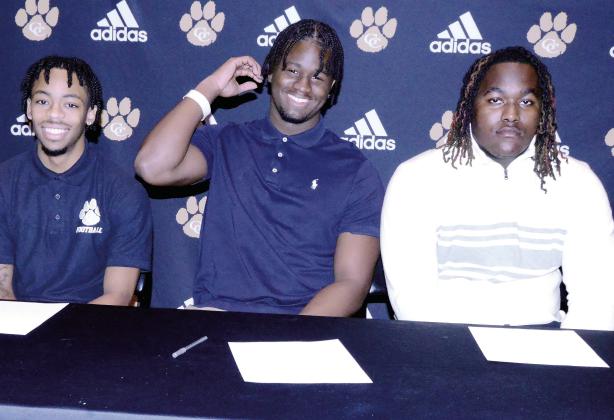 (From L to R): Chris Lowe, Jamarion Evans, and Dayshaun Copeland pose for a photo after their signing ceremony. IAN TOCHER/Staff