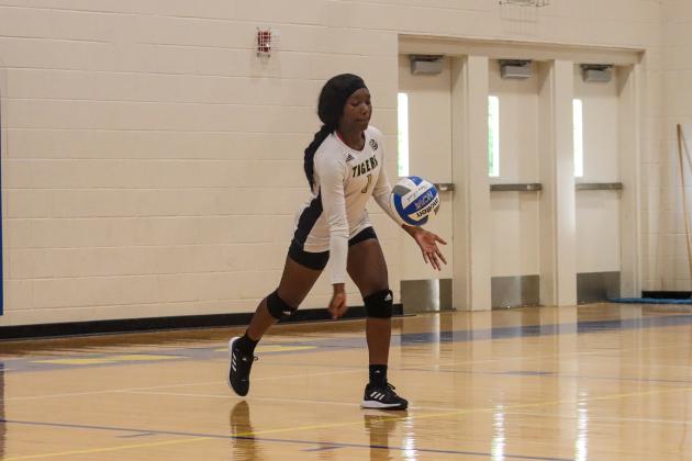 Ariana Ross (1) gets ready to send a serve over the net. LANCE McCURLEY/Staff