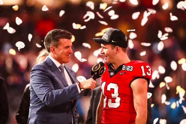 ESPN’s Rece Davis (left) interviews Georgia quarterback Stetson Bennett (13) following the Bulldogs’ 65-7 victory over the No. 3 TCU Horned Frogs n the 2023 CFP national championship game on Monday, Jan. 9 at SoFi Stadium. (Photo courtesy of UGA Athletics)