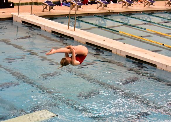 Caroline Jenkins tries to complete a tuck dive during the state meet on Tuesday.