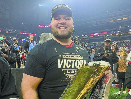 Former Gatewood Gators All-State player Weston Wallace enjoys a moment with the national championship trophy after helping UGA secure its second-straight title-winning season. (Photo/UGA Athletics)