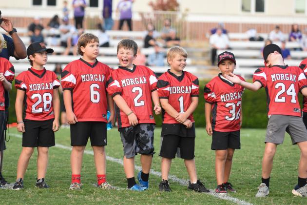 Members of a Morgan County youth football team take the field before the game. LANCE MCCURLEY/Staff