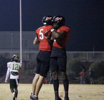 Davis Strickland (left) and Jae Benford (right) celebrate after the pair hooked up for a touchdown. TREY NORRIS/Staff