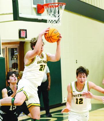 Gators coach Don Keiser singled out “big man” Trey Wiggins (21) for his physical play and scoring touch in a 71-36 win over Westfield last Saturday night in Eatonton. Meanwhile, Gatewood’s top scorer Matt Allen (12) continued to rack up points, scoring 31 for the home team. IAN TOCHER/Staff