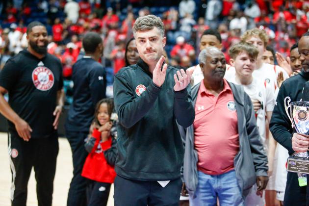 After the final buzzer, Morgan County head coach Cody Anderson clapped and cheered as the Dogs celebrate their 53-52 overtime victory. LANCE MCCURLEY/Staff