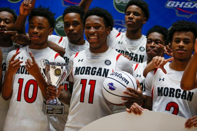 Morgan County senior Zeki Locus (11) celebrates with teammates after the Dogs defeated Butler 53-52 in the GHSA Class 2A state championship on March 14 at the Macon Coliseum. LANCE MCCURLEY/Staff