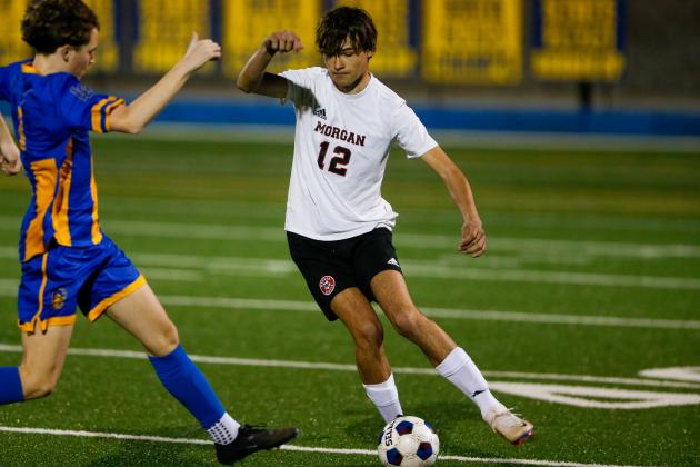 Senior Rob Bennett (12) dribbles the ball past a defender. LANCE McCURLEY/Staff