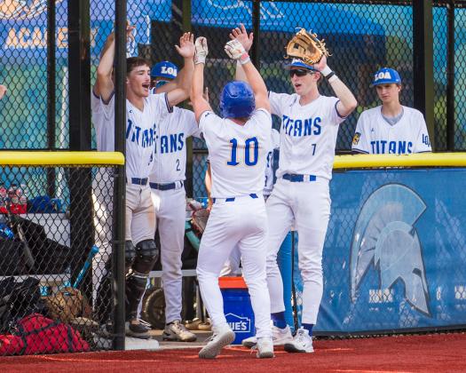 Lake Oconee Academy’s Griffin Stanford (10) celebrates with his teammates as he returns to the dugout after hitting a home run against Treutlen. SKYLA MORRIS/Staff