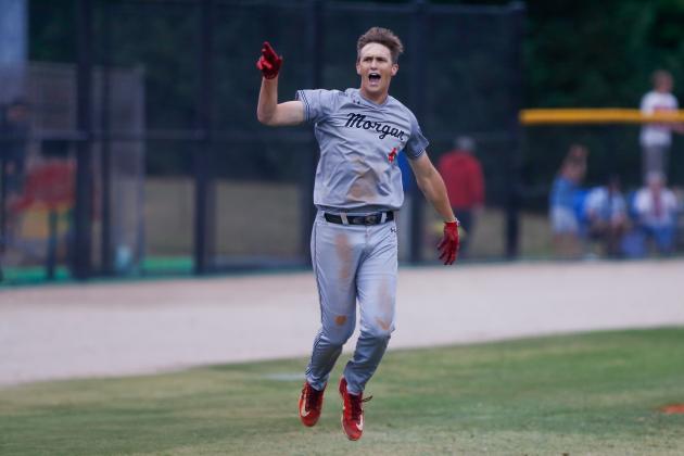 Morgan County senior Davis Strickland rounds third base, tosses his helmet into the air and celebrates after hitting a game-winning grand slam against Stephens County, securing an Elite Eight berth for the Bulldogs. LANCE MCCURLEY/Staff