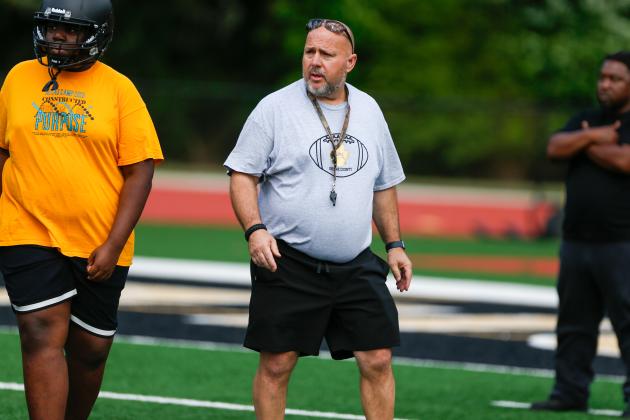 New head coach Chris MacFarland directs players through a drill during a Greene County football practice earlier this month. LANCE McCURLEY/Staff