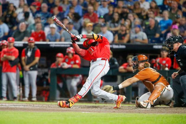 Georgia third baseman Tre Phelps blasts a single in the seventh inning against Texas on Tuesday night. LANCE McCURLEY/Staff