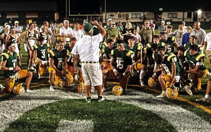 Early during the 2025 season, Gatewood head coach Jeff Ratliff (center) held court with his players, cheerleaders, and parents of both near the 50-yard line at Sammons Field in Eatonton. IAN TOCHER/Staff