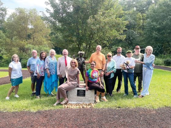 Butterflies & Blooms in the Briar Patch habitat founder Virginia Linch (far right), and the BBBP habitat’s supporters and friends gather around the “Butterfly Girl” to commemorate the reveal of the new addition at the habitat. LYNN HOBBS/Staff