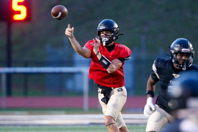 Greene County quarterback Brody Moreno fires a pass downfield to a teammate during last week’s scrimmage. LANCE McCURLEY/Staff