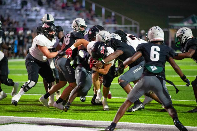 Morgan County senior running back Alex Corrias (1) powers through the heart of the Eastside defense for a touchdown. SKYLA MORRIS/Staff