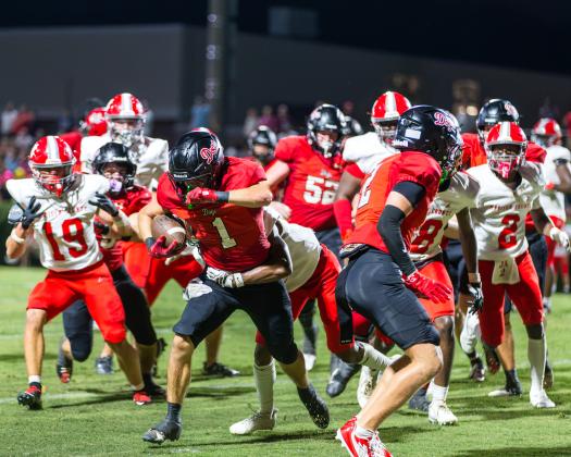 Dogs’ senior running back Alex Corrias shook off Madison County defenders in a scoring attempt during the season opener. SKYLA MORRIS/Staff