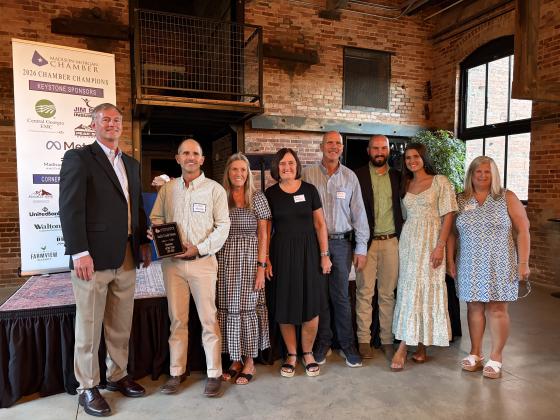 Jack’s Creek Farms Owners Damon Malcom (left) and Mark Batchelor (middle) stand alongside family members to accept the 2026 Business of the year award. SKYLA MORRIS/Staff