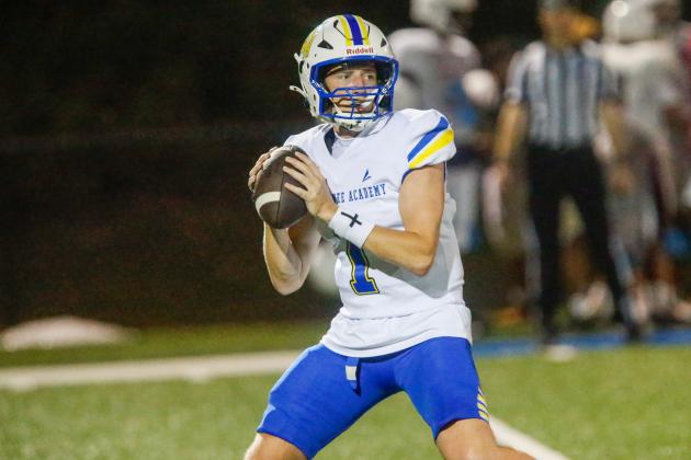 Lake Oconee Academy junior quarterback Jake McDonald drops back to pass during a scrimmage against The Walker School on Aug. 7. McDonald completed 8 of 10 passes for 92 yards and rushed for a 1-yard touchdown in the Titans’ win over Greenville last Friday. LANCE MCCURLEY/Staff
