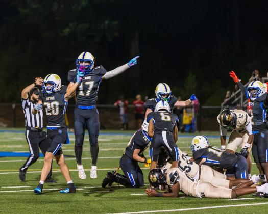 Luis Rodriguez (17), and Jon Funderburke (20) celebrate and signal a fumble recovery during the second quarter of last week’s game. SKYLA MORRIS/Staff