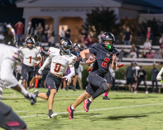 Dogs senior wide receiver Cole Wesley runs past a Hebron defender in attempt to score during their Sept 25 game. SKYLA MORRIS/Staff