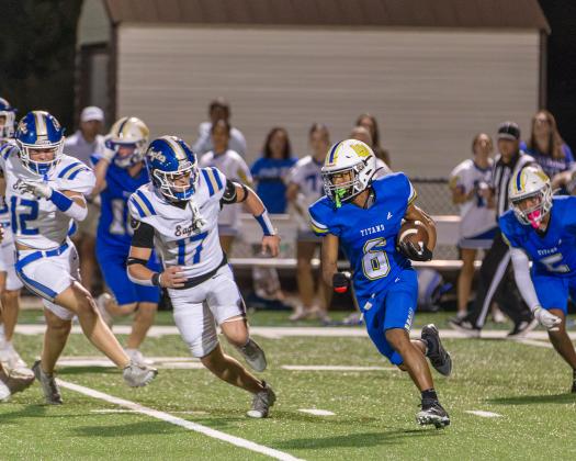 Titans senior running back Kam Geter attempts a kick return in a game earlier in the season. SKYLA MORRIS/Staff