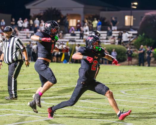 Dogs wide receiver Cole Wesley (2), celebrates his game-winning one-yard touchdown alongside running back Alex Corrias (1). SKYLA MORRIS/Staff