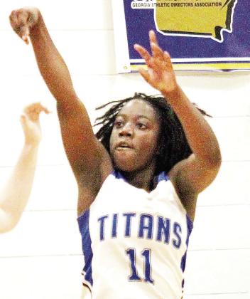 Junior Lady Titans' guard Briana Glave (11) throws up a shot from beyond the arc. TREY NORRIS/Staff