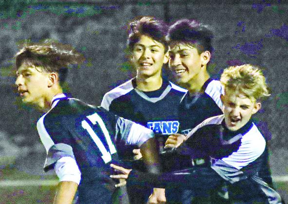 Leonardo Perez (10) and Palmer Larkin (3) celebrate with teammates last season after the Titans scored a goal. Larkin and Perez have helped lead this year’s offense as well. FILE PHOTO