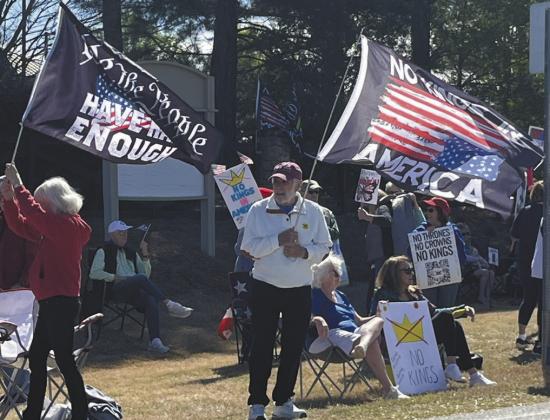 Protestors wave flags at the No Kings rally last Saturday in Greensboro. T. MICHAEL STONE/Staff