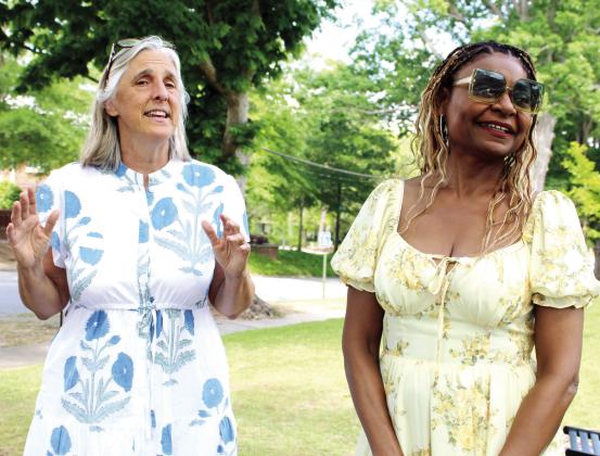 Greene County African American Museum Board of Directors member Jill Lum, left, and Abram Colby’s granddaughter, Pamela Colby, lead the crowd in an interactive introduction to the program. LYNN HOBBS/Staff