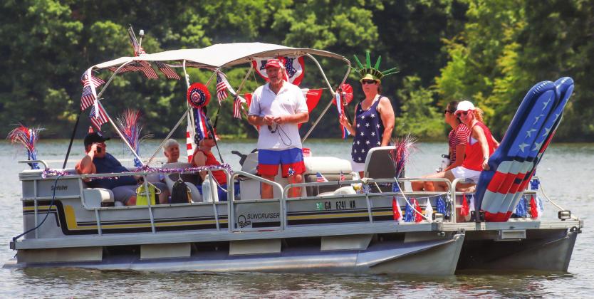 Mark Ruehle (center), along with his friends and family, get ready to participate in the third-annual Lake Oconee Boat Parade.