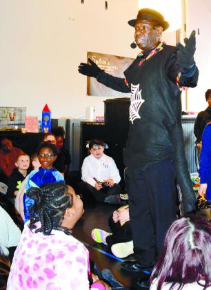 Jerry G. White, author of Anansi and the colorful kente cloth, gave a spirited, interactive performance while dressed as his title character.