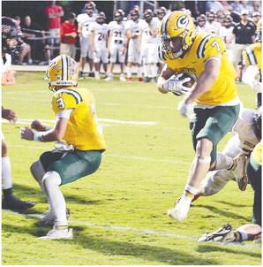 With Jackson Hewatt (3) providing cover, Evan Bennett (7) makes his way across the goal line for Gatewood’s first touchdown last Friday night in a 17-8 win over Briarwood. IAN TOCHER/Staff