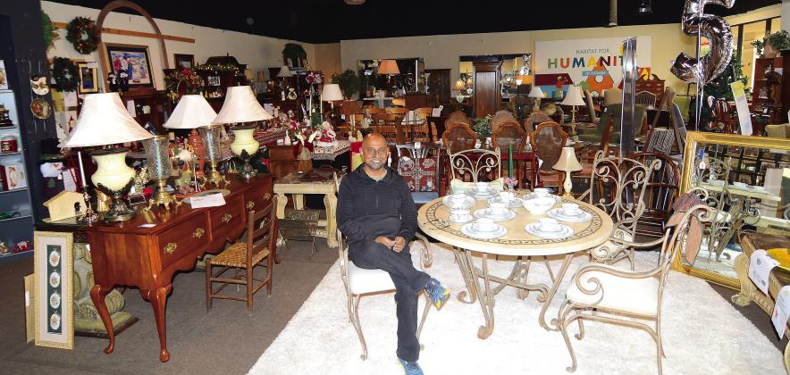 Putnam HFH Executive Director Murali Thiramul sits amidst the crowded showroom of furniture and housewares at the current Habitat Restore on Lake Oconee Parkway. IAN TOCHER/Staff