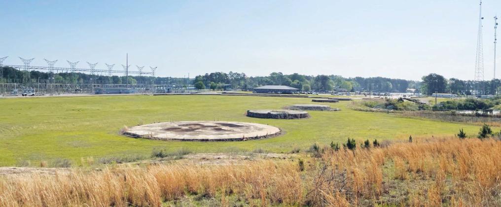 All that’s left of the once-mighty, 1,007-feet-tall smokestack that towered over Plant Branch is a circular concrete base in an open field. Built in 1978, the smokestack was dropped in a controlled demolition on Oct. 15, 2016. COURTESY GEORGIA POWER