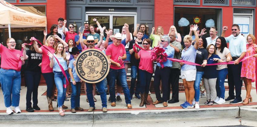 Crooked D Creamery founders and owners David Hodge (center, with scissors) and his wife, Jesse (center, sunglasses), welcomed a sizable crowd of well-wishers May 28 for their official ribbon cutting ceremony at 110 N. Jefferson Ave., in downtown Eatonton.