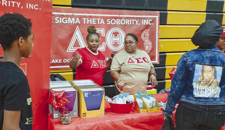 Delta Sigma Theta volunteers hand out school supplies to students and their families. CONTRIBUTED
