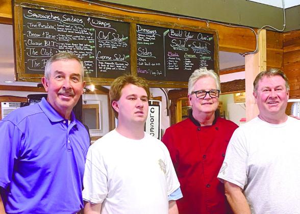 L-R: Greene County Commissioner Jeffery Smith visits with Jack Leach, Ken McCord and Brent Leach during the first delivery of Jack’s Cheesecakes to Ripe Thing Market in Greensboro. MAUREEN STRATTON/Staff