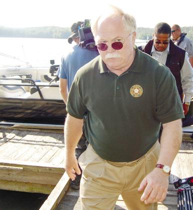 Sheriff Howard Sills exits a boat after recovering the body of Shirley Dermond from the waters of Lake Oconee.