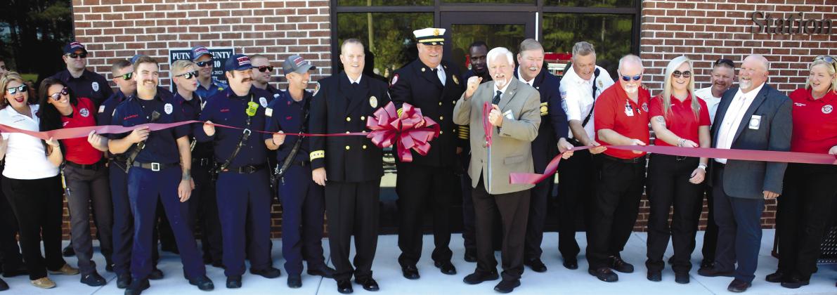 With Putnam County Fire Chief Tom McClain by his side, County Commission Chairman Bill Sharp enthusiastically cut the ceremonial ribbon to officially open the county’s new fire/EMS/coroner facility north of Eatonton, alongside the bypass. IAN TOCHER/Staff
