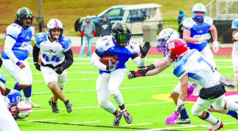 Greene County running back Malik West (5) runs past defenders on his way for a first down. LANCE McCURLEY/Staff