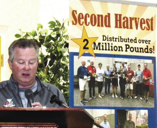 Second Harvest President Bill Bonnington congratulates volunteers and sponsors for helping achieve a record 2 million pounds of food distributed by the organization since 2008. MARK ENGEL/Staff