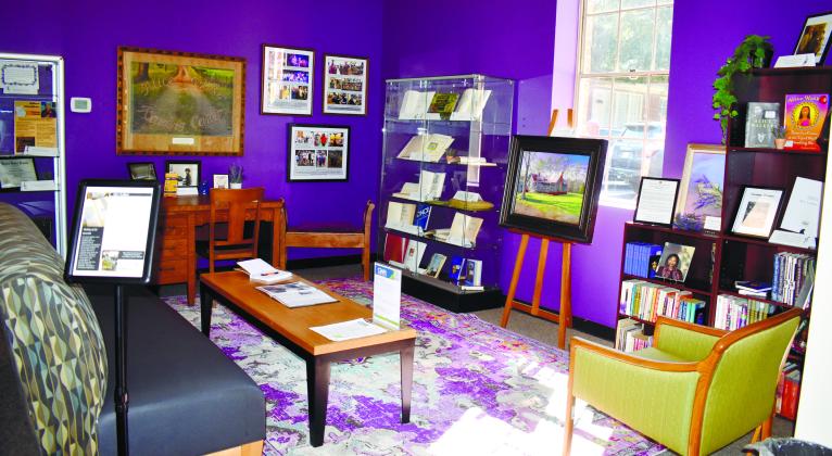 The Alice Walker mini-musuem sits to the right of the door inside the library and features a variety of signed books, books to read, history on Walker’s life, and a desk to write at. BAILEY MCCULLY/Staff
